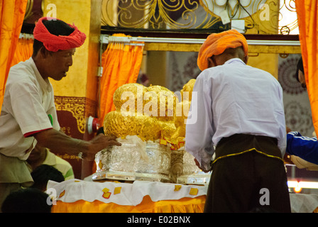 The staff of the Inle Lake festival preparing the Buddha images. Stock Photo