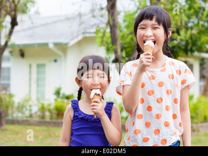 Cute little Girls Eating Ice Cream Stock Photo