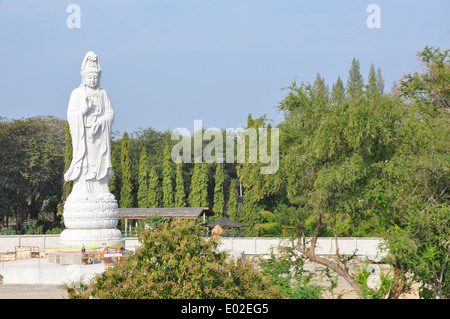 White marble statue of Buddha over the Mae Klong River, Kanchanaburi, Thailand. Stock Photo