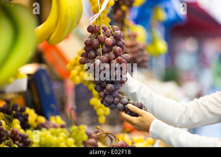 Female close-up hand grape banana Stock Photo