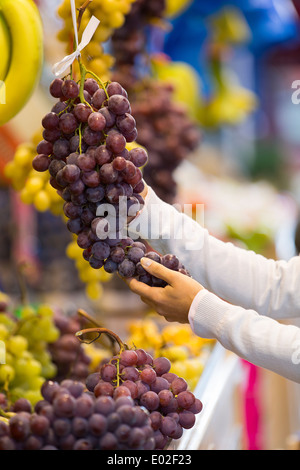 Female close-up hand grape banana Stock Photo