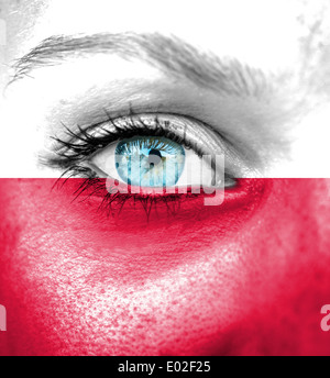 Woman face painted with flag of Poland Stock Photo