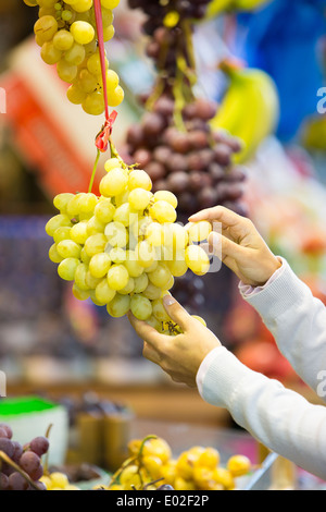 Female close-up hand grape banana Stock Photo