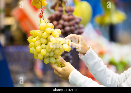 Female close-up hand grape banana Stock Photo