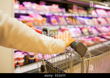 Female trolley supermarket shop background Stock Photo