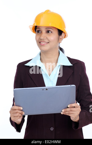 Young Indian female engineer with tablet against white background Stock Photo