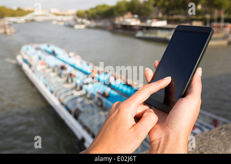 Close up of hands Female mobile phone houseboat seine bridge message sms e-mail Stock Photo