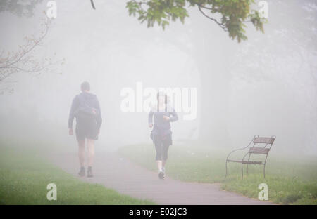 Bristol, UK. 30th Apr, 2014. Morning joggers run through the heavy fog in Bristol. The Met Office issued a yellow weather warning for southern England and Wales due to dense fog - which has led to disruption of morning flights in London and Bristol. 30 April 2014 Credit:  Adam Gasson/Alamy Live News