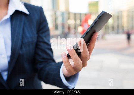 Female Mobile phone hand outdoor message sms e-mail Stock Photo