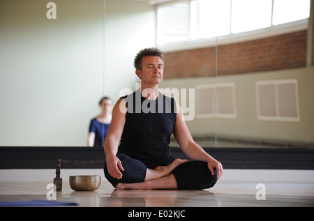 A yoga teacher and class meditating at a Birmingham arts centre Stock Photo