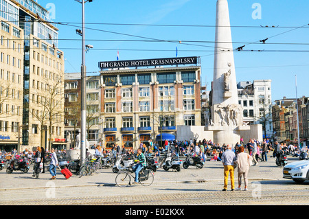 People relaxing in Dam Square outside NH Grand Hotel Krasnapolsky, Amsterdam, Netherlands Stock Photo