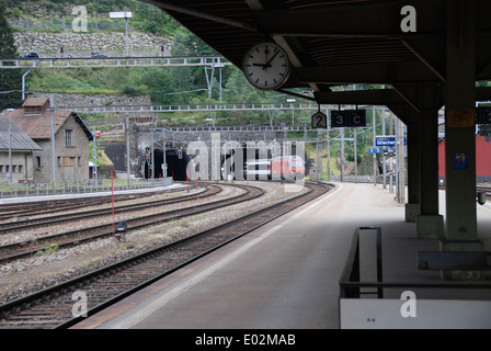 Goschenen railway station in Switzerland looking towards northern entrance of St. Gotthard Tunnel with train emerging. Stock Photo