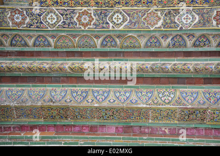 Ornamental ceramic tiles on the wall of a pavilion on the grounds of the Grand Palace, Bangkok. Stock Photo