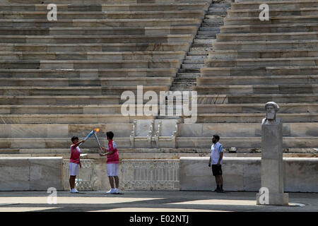 Athens, Olympic Flame from first torch bearer Greece's fencing athlete Marios Giakoumatos during a handover ceremony at Panathenaean Stadium in Athens. 30th Apr, 2014. China's tennis athlete Sun Ziyue (L), receives the Olympic Flame from first torch bearer Greece's fencing athlete Marios Giakoumatos during a handover ceremony at Panathenaean Stadium in Athens, April 30, 2014. The flame for the Nanjing Youth Olympics was lit in Athens on Wednesday to mark the symbolic start of the torch relay ahead of the games. © Marios Lolos/Xinhua/Alamy Live News Stock Photo