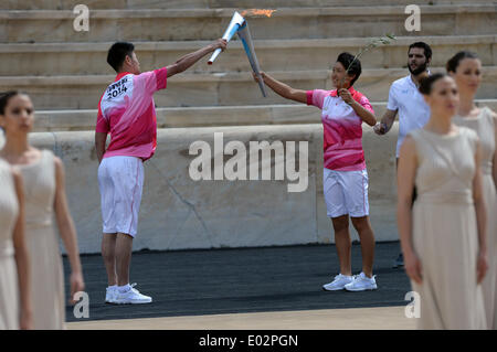 Athens, Olympic Flame from his compatriot Sun Ziyue during a handover ceremony at Panathenaean Stadium in Athens. 30th Apr, 2014. China's tennis athlete Jiang Fan(L), receives the Olympic Flame from his compatriot Sun Ziyue during a handover ceremony at Panathenaean Stadium in Athens, April 30, 2014. The flame for the Nanjing Youth Olympics was lit in Athens on Wednesday to mark the symbolic start of the torch relay ahead of the games. © Han Yuqing/Xinhua/Alamy Live News Stock Photo