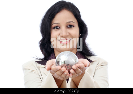Young Indian business woman holding puzzle globe against white Stock Photo
