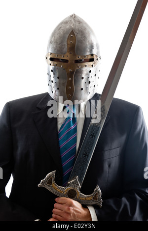 A Young Businessman isolated on a white background holding a steel sword and wearing a helmet Stock Photo