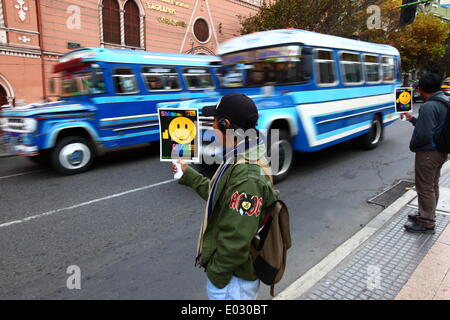 LA PAZ, BOLIVIA, 30th April 2014. A student with an AC/DC "Highway to Hell" album badge on his jacket holds a placard during No Horn Day / Dia de la No Bocina, part of a campaign to encourage drivers to use their horn less and to reduce noise pollution in the city. La Paz is notorious for its chaotic traffic; the City Hall frequently runs campaigns regarding road safety, to reduce congestion and similar. Credit:  James Brunker/Alamy Live News Stock Photo