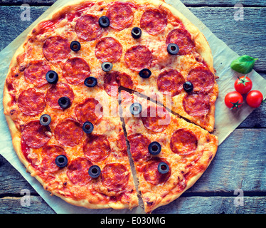 Homemade pepperoni pizza from above on the wooden background Stock Photo