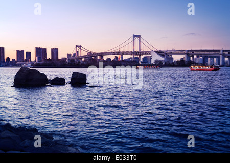 Rainbow bridge across Tokyo Bay in sunset. View from Odaiba, Tokyo, Japan. Stock Photo