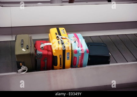 Colorful suitcases, luggage on airport baggage claim conveyor carousel, Narita International Airport, Japan Stock Photo