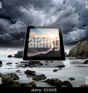 Image of a serene beach sunset on a digital tablet Stock Photo