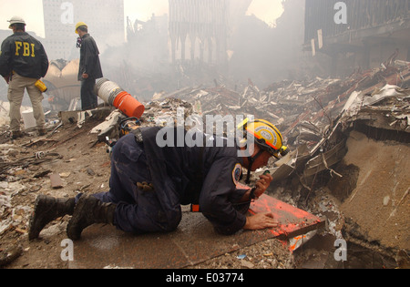 Urban Search and Rescue workers continue the recovery of victims amongst the wreckage of the World Trade Center in the aftermath of a massive terrorist attack which destroyed the twin towers killing 2,606 people September 19, 2001 in New York, NY. Stock Photo