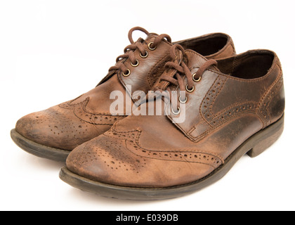 Old worn out brown shoes isolated on a white background Stock Photo