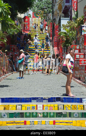 RIO DE JANEIRO, BRAZIL - FEBRUARY 13, 2014: Tourists visit the colorful mosaic tiles at the Selaron Steps in Lapa. Stock Photo
