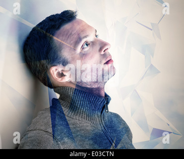 Young dreamy man conceptual portrait with technology pattern Stock Photo