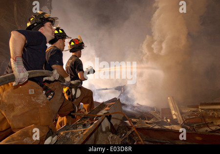 New York City Firemen battle fires amongst the wreckage of the World Trade Center in the aftermath of a massive terrorist attack which destroyed the twin towers killing 2,606 people September 19, 2001 in New York, NY. Stock Photo