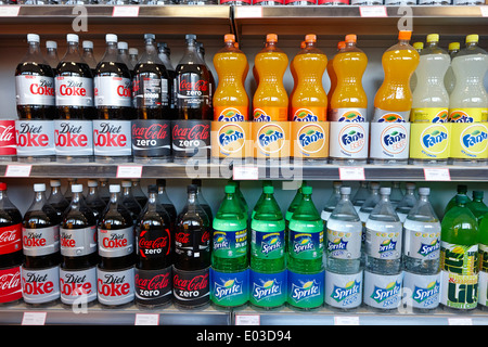 rows of 2 litre bottles of fizzy drink on display in a filling station convenience store in northern ireland Stock Photo