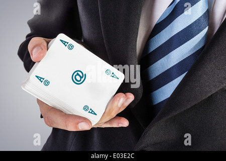 an elegant young businessman showing an ace in his hand Stock Photo