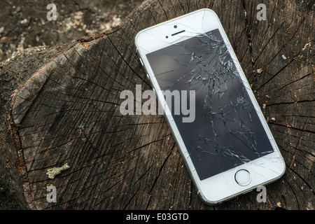 Broken white iphone glass on wood Stock Photo