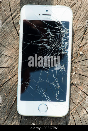 Broken white iphone glass on wood Stock Photo