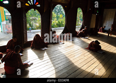 Novice monks learning in the teak wood building of Shwe Yan Pyay Monastery Stock Photo