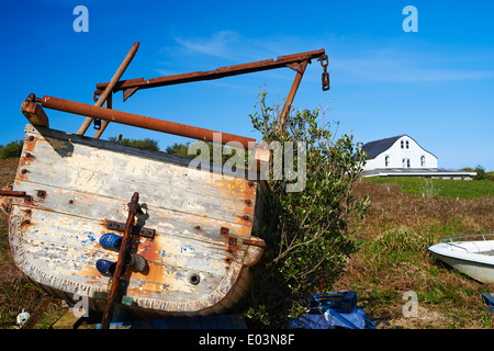 old fishing boat and house with curved roof to deflect the wind on Gugh, Isles of Scilly, Scillies, Cornwall in April Stock Photo