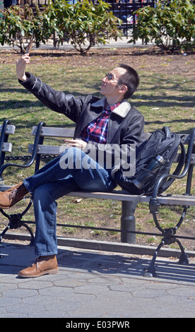 A man takes a selfie in Washington Square Park in Manhattan Stock Photo
