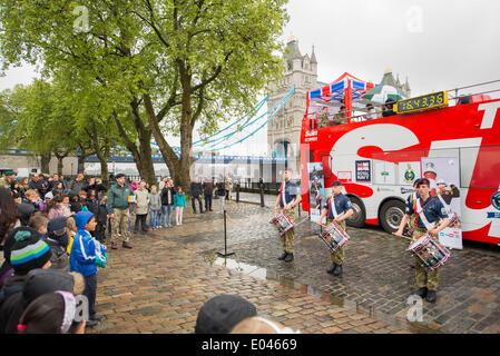 Tower of London, UK. 1st May 2014. As part of the Royal Marines 350th anniversary celebrations, the men and women of the Corps of Drums of Her Majesty’s Royal Marines Band Service are attempting to break the current world record for the longest continuous drum roll. The attempt started on 30th April and should finish on 3rd May 2014. A drum display entertains visitors in front of Tower Bridge. Credit:  Malcolm Park editorial/Alamy Live News Stock Photo