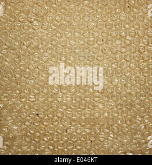 Plastic bubble packaging material on brown background Stock Photo