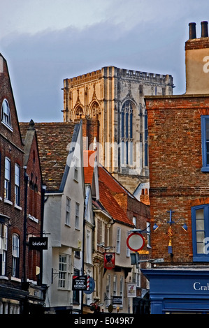 York Minster tower peeks above surrounding buildings in the centre of the city of York. Stock Photo