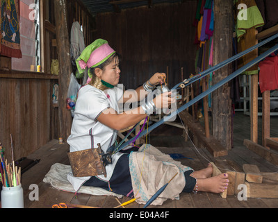 Long neck Paudaung woman (ethnic Karen aka Kayan people) weaving on a back strap loom, Inle Lake, Myanmar Stock Photo