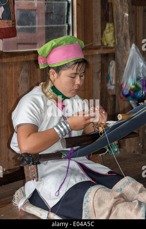 Long neck Paudaung woman (ethnic Karen aka Kayan people) using a back strap loom, Inle Lake, Myanmar Stock Photo