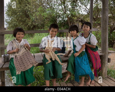School children and their pet cat, Inle Lake, Myanmar Stock Photo