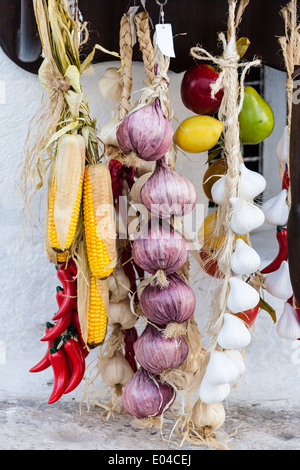 hanged onions, garlics and peppers in a Mediterranean market Stock Photo