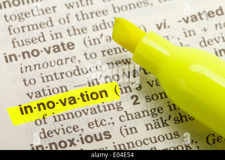 The Word Innovation Highlighted in Dictionary with Yellow Marker Highlighter Pen. Stock Photo