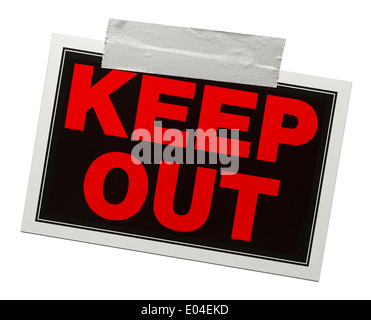 Red and black keep out sign with tape holding it up isolated on a white background. Stock Photo
