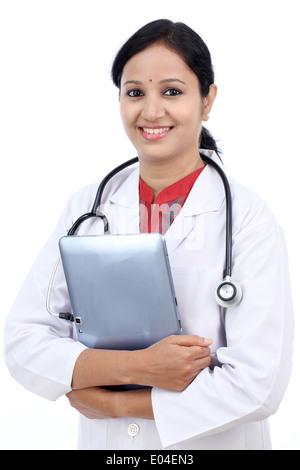 Young female doctor with tablet against white background Stock Photo