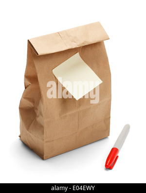 Brown Paper Bag Lunch with copy space and sticky note plus marker isolated on a white background. Stock Photo
