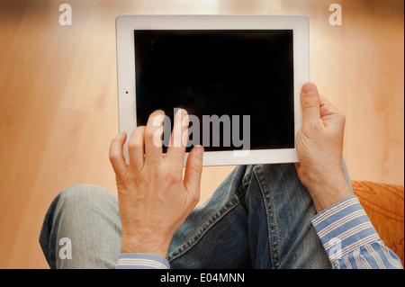 man hands holding and using a tablet computer, blank screen Stock Photo